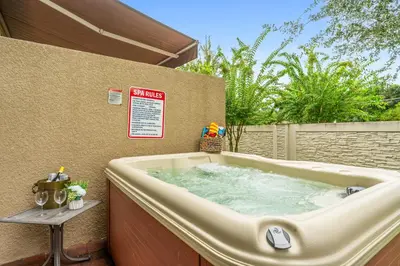 a large bath tub sitting on a patio at 5min Disney Lovely Villa Hot tub 130 in Orlando