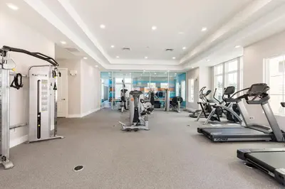 a gym with treadmills and cardio equipment in a building at Precious Townhome w BBQ 131 in Orlando