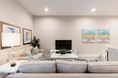 a living room with a couch and a tv at Fantastic Townhome 5min Disneyworld 134 in Orlando