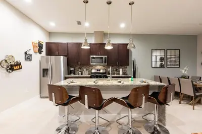 a kitchen with a large island in the middle of a room at Beautiful Family Villa Patio area with BBQ 5min Disney in Orlando