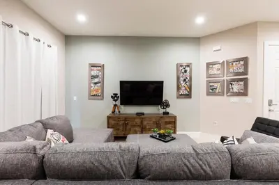 a living room with a couch and a flat screen tv at Beautiful Family Villa Patio area with BBQ 5min Disney in Orlando