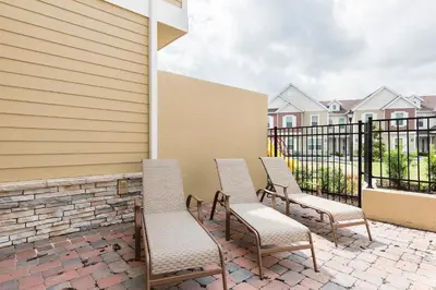a group of chairs sitting on a patio at Beautiful Family Villa Patio area with BBQ 5min Disney in Orlando