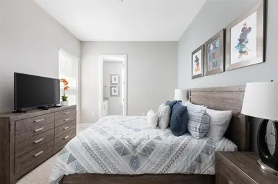 a bedroom with a bed and a flat screen tv at Amazing Hidden Gem, Min Disney 139 in Orlando