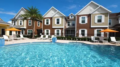 a large swimming pool in front of some houses at Amazing Hidden Gem, Min Disney 139 in Orlando