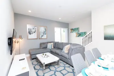 a living room with a couch and a table at Amazing Family Villa, 5min Disney SMV144 in Orlando