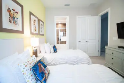 a bedroom with two white beds and a tv at Amazing Family Villa, 5min Disney SMV144 in Orlando