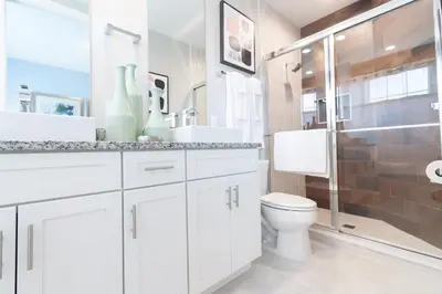 a white bathroom with a toilet and a shower at Amazing Family Villa, 5min Disney SMV144 in Orlando