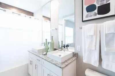 a white bathroom with two sinks and a mirror at Amazing Family Villa, 5min Disney SMV144 in Orlando