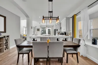 a kitchen and dining room with a table and chairs at Large 6BR Themed Family Villa Near Disney world in Kissimmee