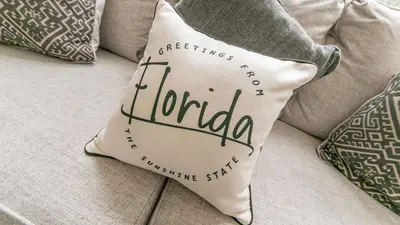 a cushion on a couch with pillows on it at Large 6BR Themed Family Villa Near Disney world in Kissimmee