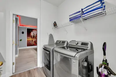 a laundry room with a washer and dryer in it at Large 6BR Themed Family Villa Near Disney world in Kissimmee