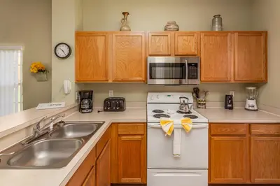 a kitchen with a sink and a stove and microwave at Emerald Island-RU1029 in Kissimmee