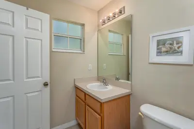 a bathroom with a sink and a mirror at Emerald Island-RU1029 in Kissimmee