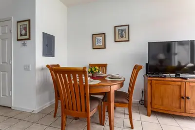 a dining room with a table and a television at Windsor Palms-RU831 in Kissimmee