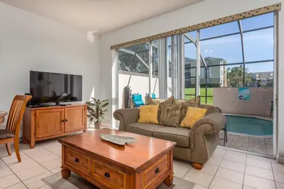 a living room with a couch and a tv at Windsor Palms-RU831 in Kissimmee