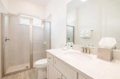a bathroom with a toilet and a sink and a shower at Sea Breeze Cottage Near Disney With Margaritaville Resort & Island H20 Waterpark Access - 2982La in Orlando