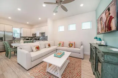 a living room with a couch and a table at Sea Breeze Cottage Near Disney With Margaritaville Resort & Island H20 Waterpark Access - 2982La in Orlando