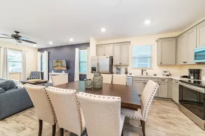 a kitchen and dining room with a table and chairs at Ocean Waves Cottage Near Disney With Margaritaville Resort & Island H20 Waterpark Access - 2983La in Orlando