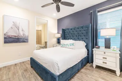 a bedroom with a large bed with a blue headboard at Ocean Waves Cottage Near Disney With Margaritaville Resort & Island H20 Waterpark Access - 2983La in Orlando