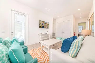 a living room with a couch and a table at Coral Reef Cottage! Near Disney With Margaritaville Resort & Island H2O Access - 8052Ls in Orlando