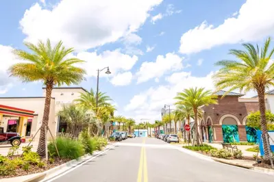 a street in a town with palm trees at Coral Reef Cottage! Near Disney With Margaritaville Resort & Island H2O Access - 8052Ls in Orlando