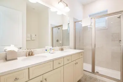a bathroom with two sinks and a shower at Coral Reef Cottage! Near Disney With Margaritaville Resort & Island H2O Access - 8052Ls in Orlando