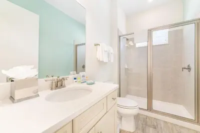 a bathroom with a sink and a toilet and a shower at Bright Cottage Near Disney With Margaritaville Resort & Island H2O Access - 8020Sb in Orlando
