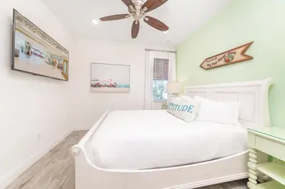 a white bedroom with a bed and a ceiling fan at Flip Inn Paradise Cottage With Private Hot Tub Near Disney With Margaritaville Resort & Island H2O Access - 8004Sb in Orlando