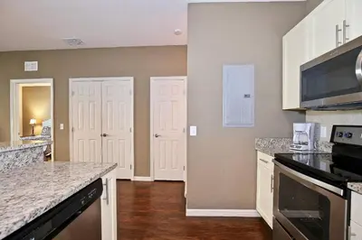 a kitchen with white cabinets and a counter top at Great townhouse in gated community West Lucaya in Kissimmee