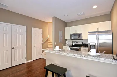a kitchen with a counter and a refrigerator at Great townhouse in gated community West Lucaya in Kissimmee