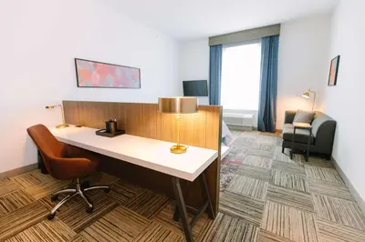 a hotel room with a desk and a chair at Hilton Garden Inn Winter Park, FL in Orlando