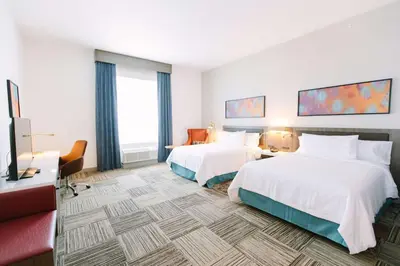a hotel room with two beds and a flat screen tv at Hilton Garden Inn Winter Park, FL in Orlando