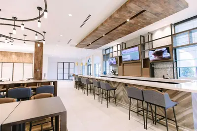 an office lobby with a long bar and chairs at Hilton Garden Inn Winter Park, FL in Orlando