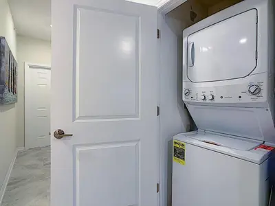a door to a kitchen with a microwave and a refrigerator at Fabulous Thematic 2BR Condo with Kids Splash Pad in Kissimmee