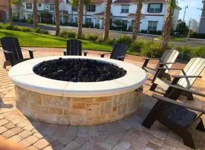 a group of benches sitting around a fire pit at Fabulous Thematic 2BR Condo with Kids Splash Pad in Kissimmee