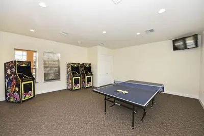 a room with a ping pong table and three chairs at Beautiful 3-Bed Villa 10 Minutes From Disney-17440 Serenity Resort townhouse in Orlando