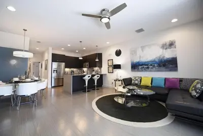 a living room and kitchen with a couch and a table at Beautiful 3-Bed Villa 10 Minutes From Disney-17440 Serenity Resort townhouse in Orlando