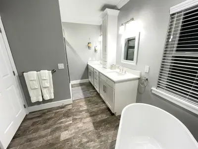 a white bathroom with a sink and a mirror at Mickeys Circle - Gorgeous! Modern 6BR, with Private South Facing Pool Hot Tub BBQ Theater 2 Miles to Disney in Orlando