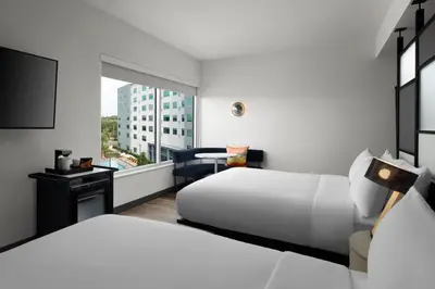 a hotel room with two beds and a window at Aloft Orlando Lake Buena Vista in Orlando