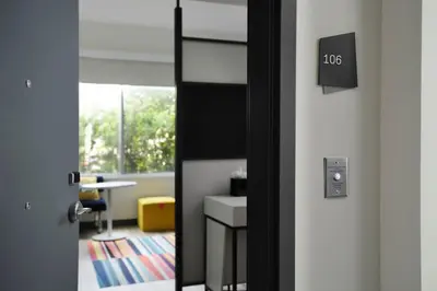 an open door to an office with a desk in a room at Aloft Orlando Lake Buena Vista in Orlando