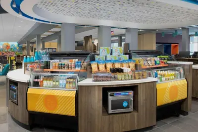 a convenience store with two checkout counters with food at Tru By Hilton Orlando Convention Center in Orlando
