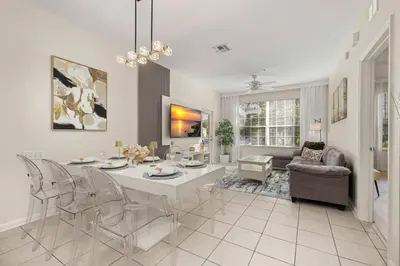 a dining room and living room with a table and chairs at Ground Floor at Windsor Hills – 5 Min Disney in Orlando