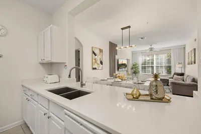 a kitchen with a sink and a counter top at Ground Floor at Windsor Hills – 5 Min Disney in Orlando