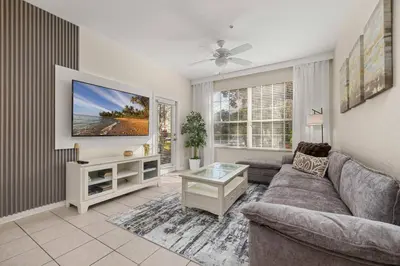 a living room with a couch and a tv at Ground Floor at Windsor Hills – 5 Min Disney in Orlando