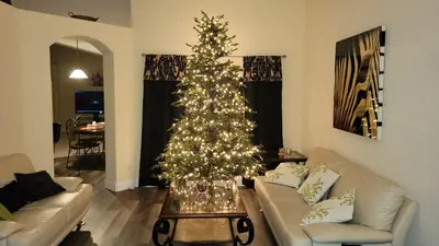 a living room with a christmas tree in the middle at Family Vacation Home With Pool and Spa Near Disney and Universal in Orlando