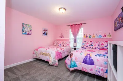 a pink bedroom with two beds and a tv at Gorgeous Four Bd w/ Pool close to Disney 5035 in Kissimmee