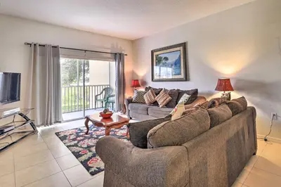 a living room with a couch and a tv at Kissimmee Condo with Resort Perks - 5 Mi to Disney! in Orlando