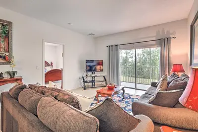 a living room with two couches and a tv at Kissimmee Condo with Resort Perks - 5 Mi to Disney! in Orlando