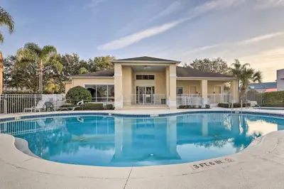 a large swimming pool in front of a house at Kissimmee Condo with Resort Perks - 5 Mi to Disney! in Orlando