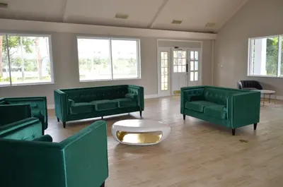 a living room with green couches and a coffee table at Altamonte Springs Hotel and Suites in Orlando